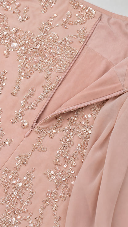 Close-up detail of delicate sequin embroidery, hidden zipper, and chiffon drape