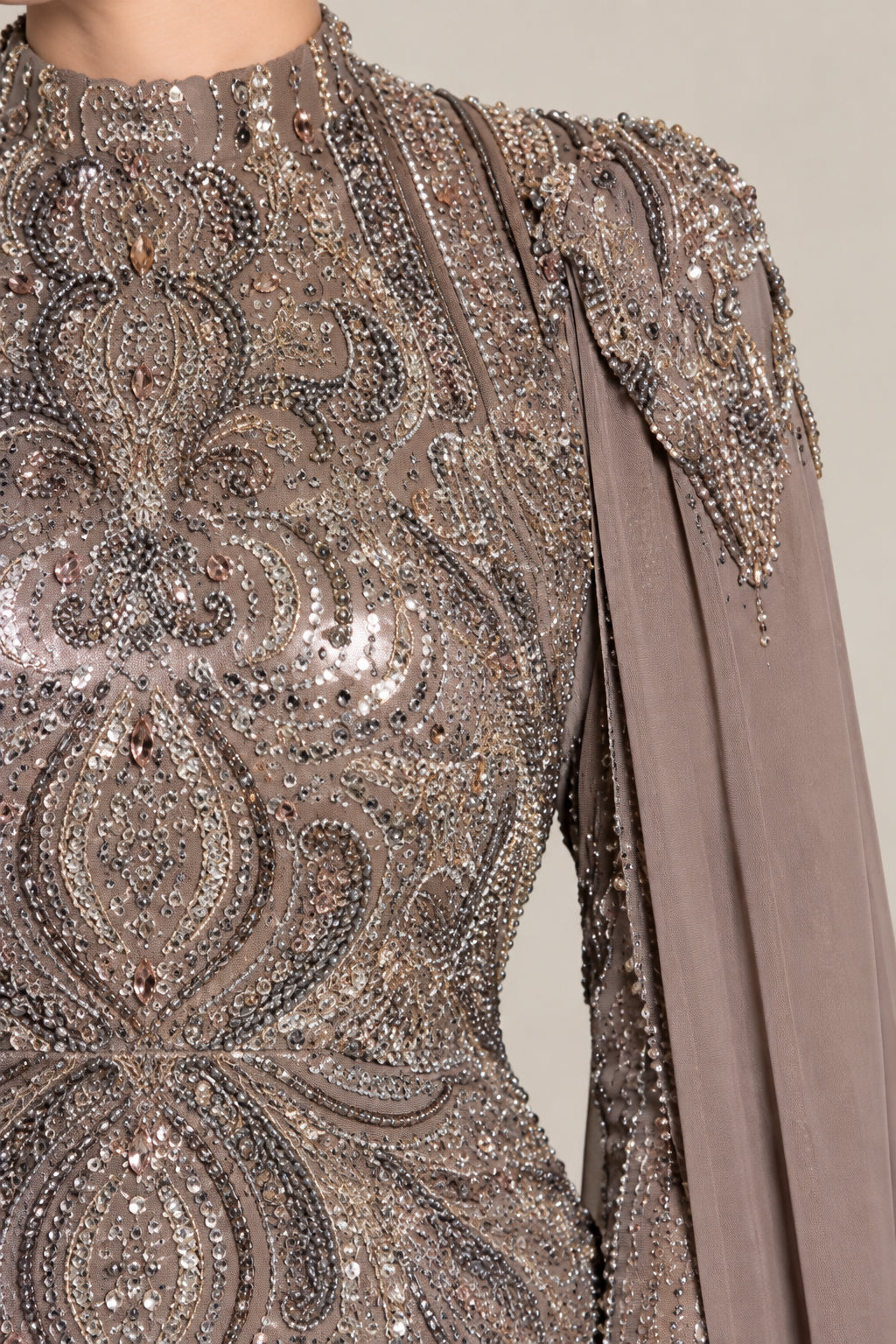 Close-up detail of intricate beadwork and sequin embroidery on high neckline and shoulder