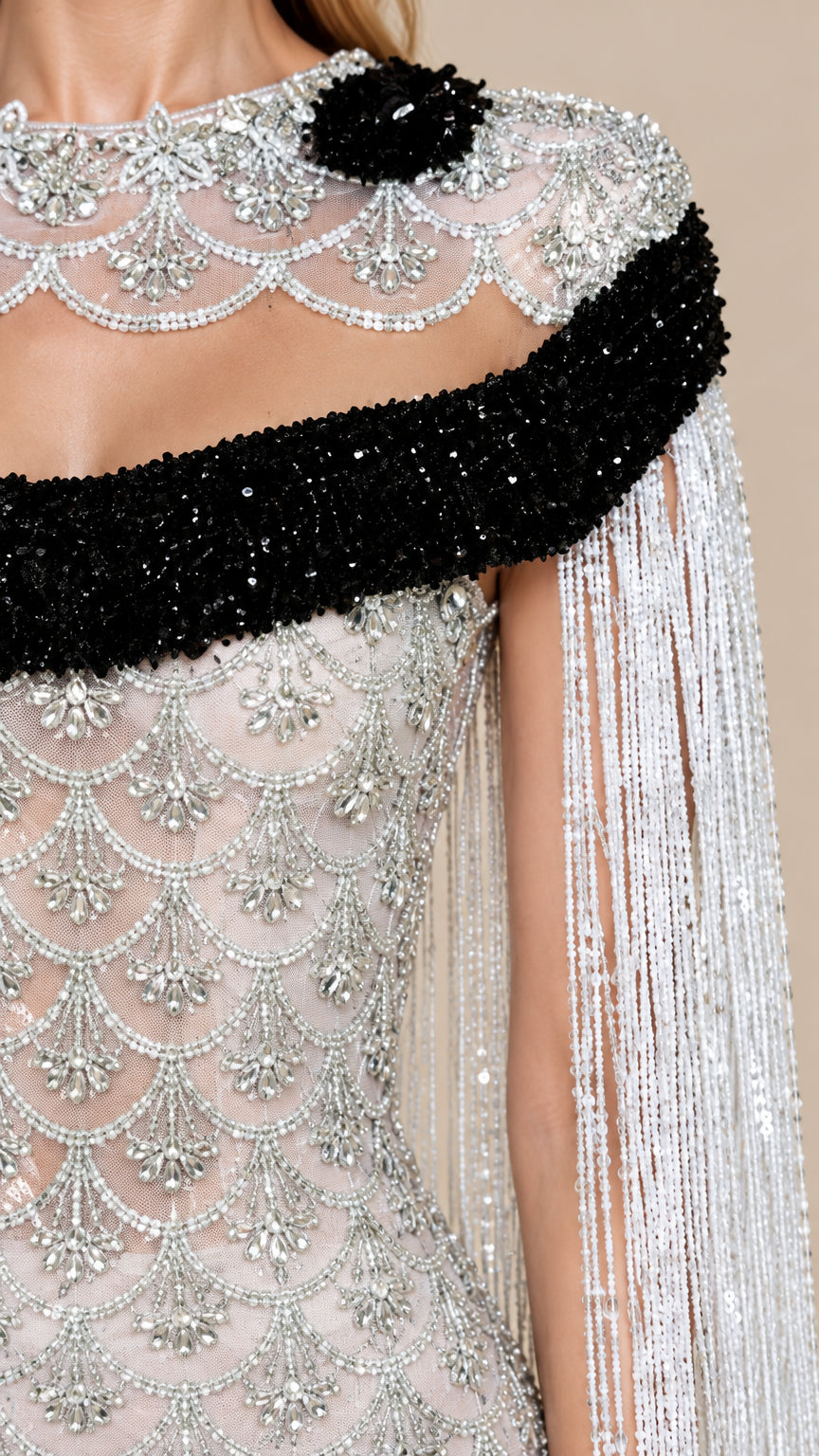 Close-up detail of silver beading, black beaded collar, and fringe cape