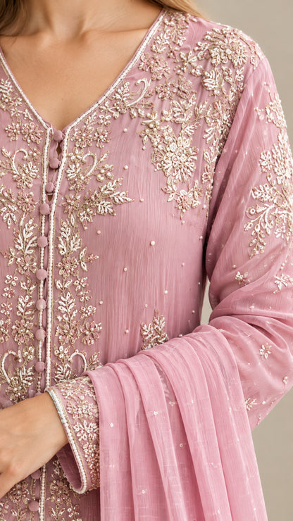 Close-up detail of delicate floral embroidery, button placket, and sleeve cuff