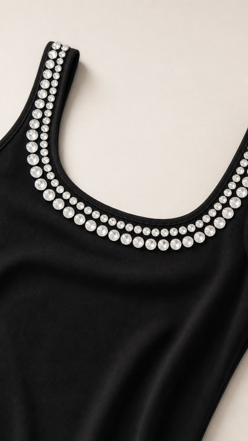 Close-up detail of sparkling crystal rhinestone trim on scoop neckline