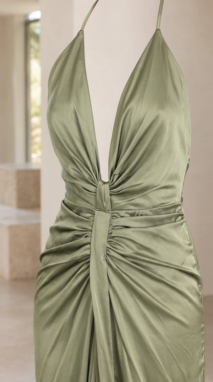 Close up view of ruched gathered waist and plunge neckline on sage green dress
