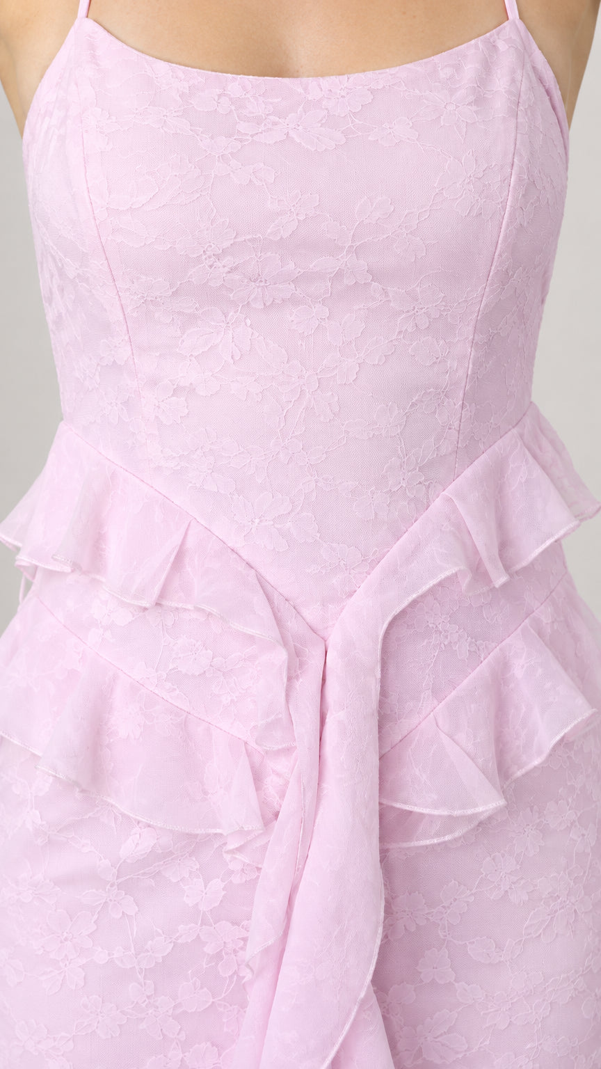 Close-up detail of pastel pink floral jacquard texture and layered waist ruffles