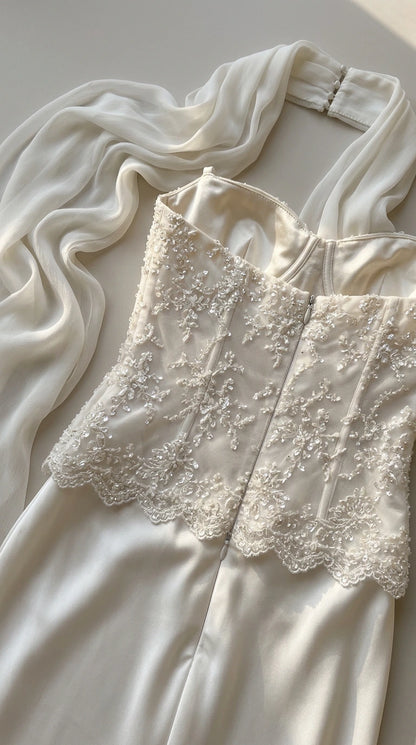Close-up detail of intricate beadwork, embroidery, and corset construction on dress bodice