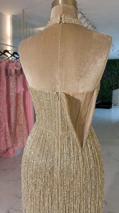 Close-up back construction of champagne gold halter gown with zipper and lining