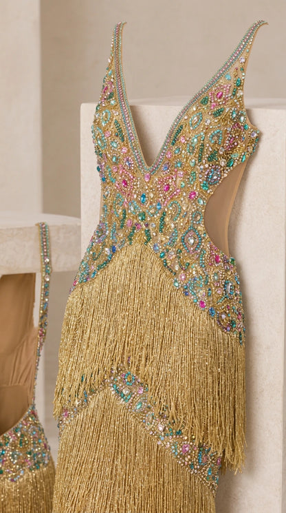 Close-up detail of multi-colored rhinestone bodice and gold fringe craftsmanship