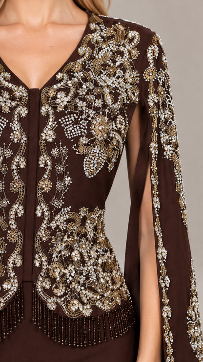 Close-up detail of intricate gold beadwork, sequins, and fringe on the gown bodice