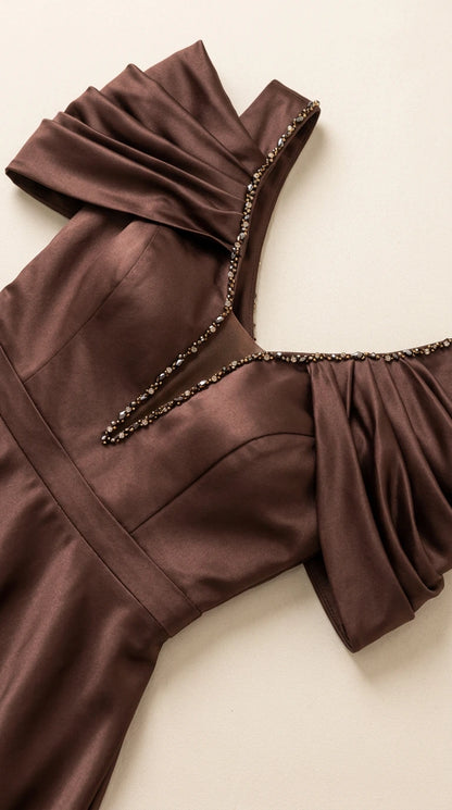 Close-up detail of beaded V-neckline and ruched shoulder sleeve