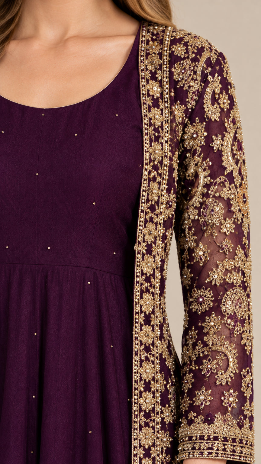 Close-up detail of scoop neckline and intricate golden lace embroidery on deep purple jacket