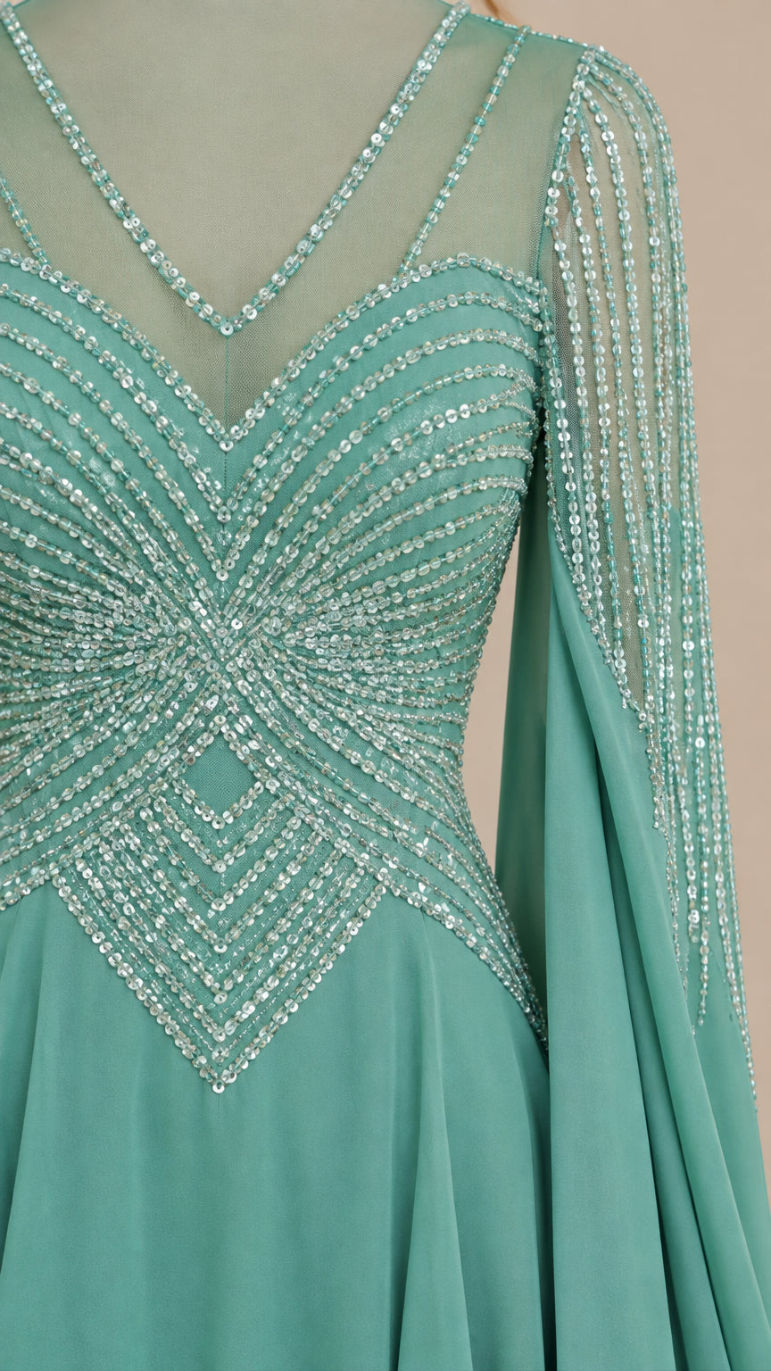 Close-up detail of geometric sequin embroidery and sheer V-neckline