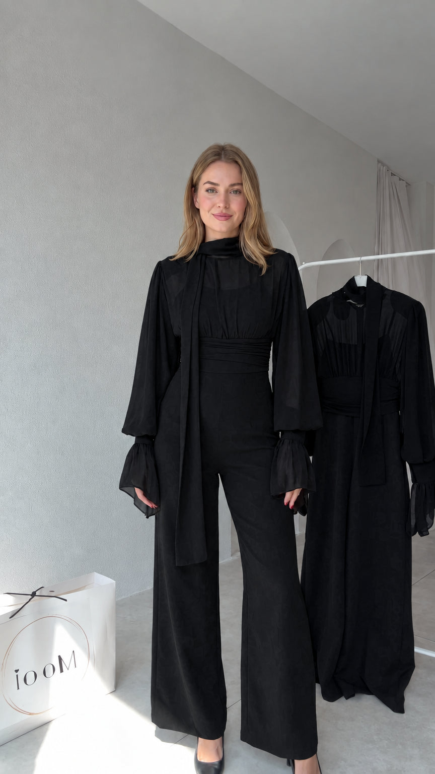 Full front view of model wearing Black tie-neck wide-leg jumpsuit