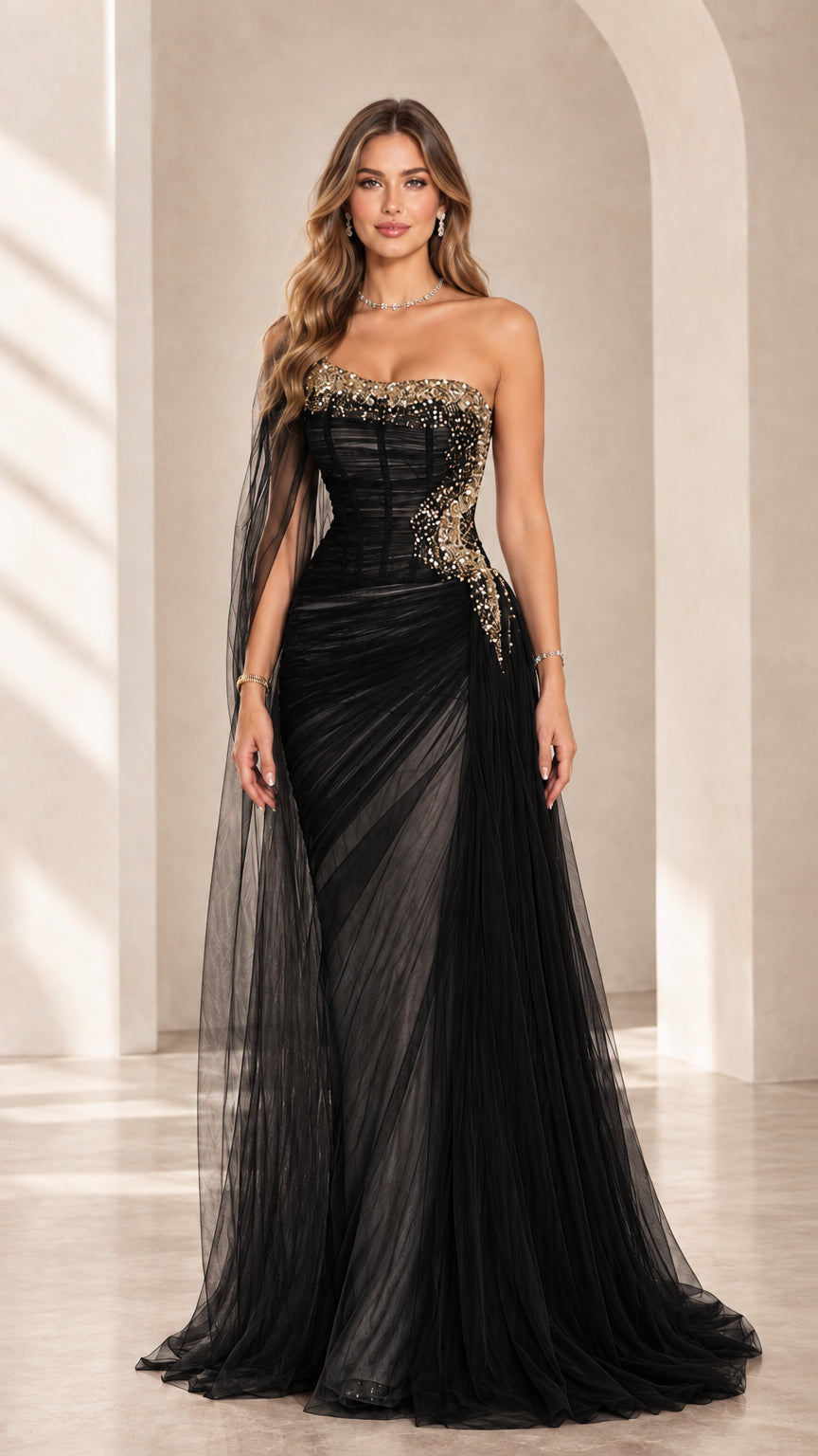 Black strapless embellished corset evening gown with one-shoulder sheer cape drape