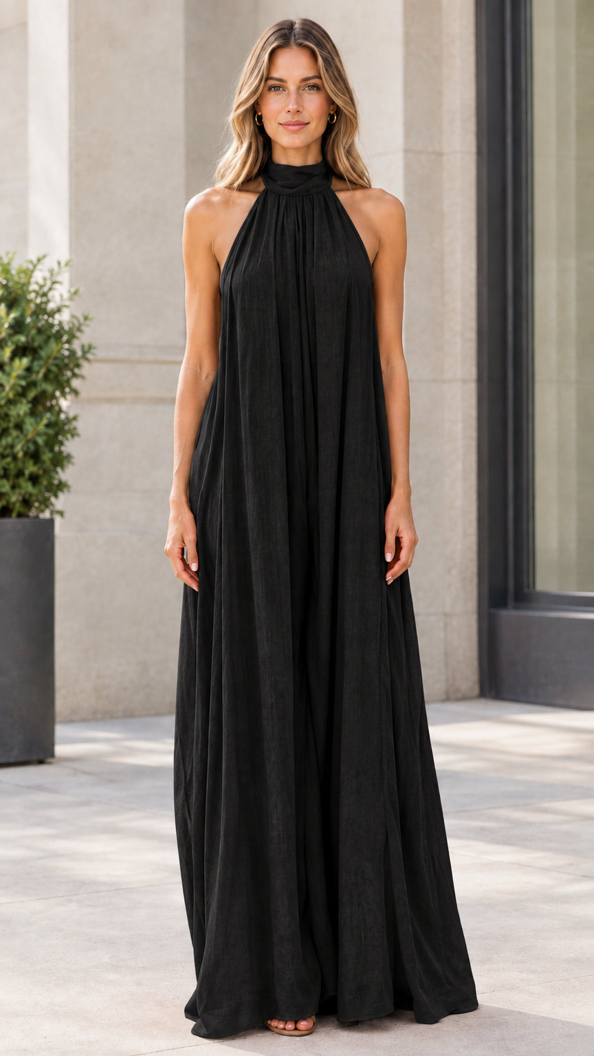 Front view of model wearing classic black halter neck wide-leg jumpsuit