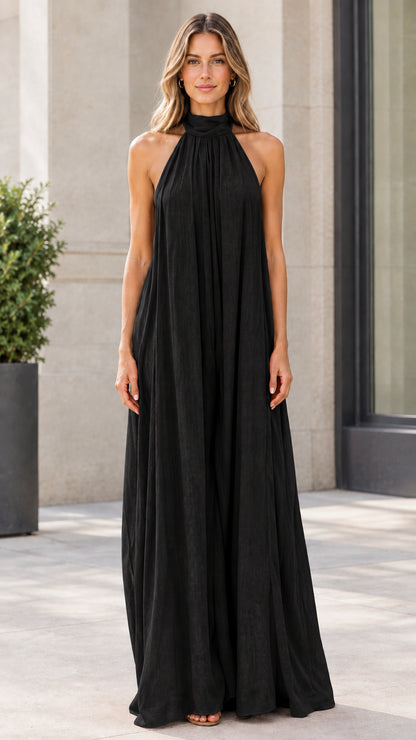 Front view of model wearing classic black halter neck wide-leg jumpsuit