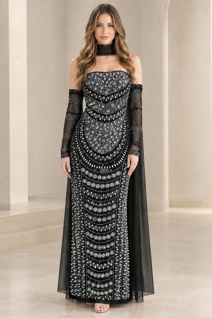 Model wearing black beaded strapless evening gown with matching choker and cape sleeves