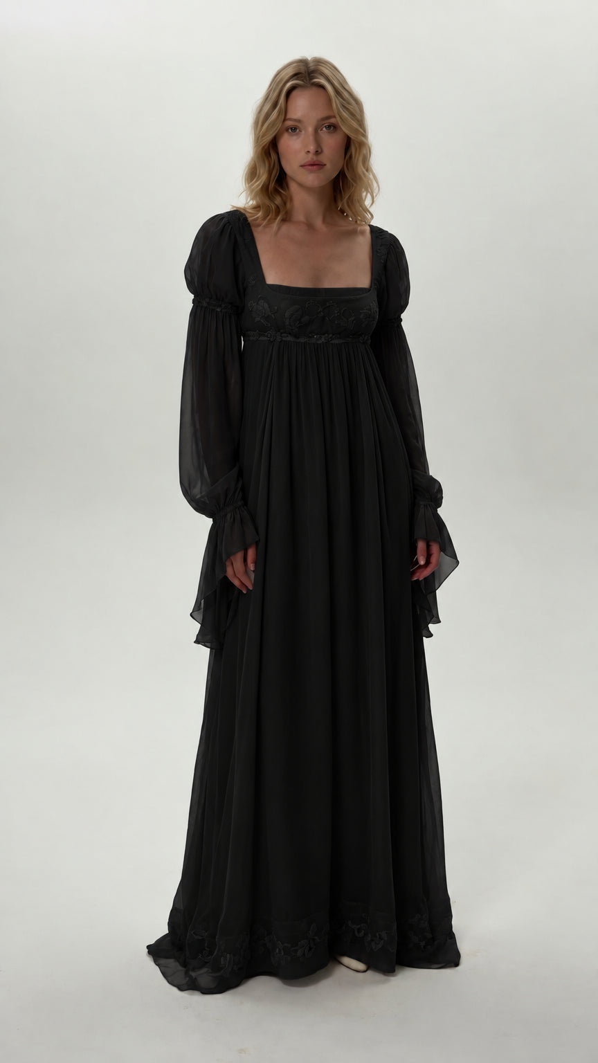 Front view of model wearing black empire waist chiffon maxi dress