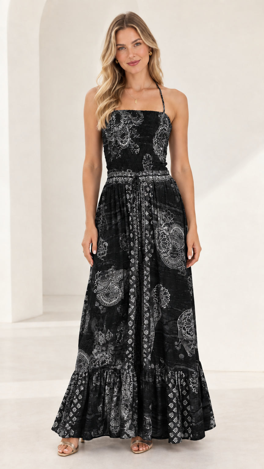 Full-length front view of black printed smocked tiered maxi dress