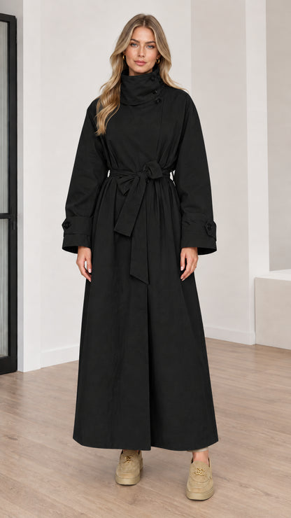 Full length view of women's black high neck maxi trench coat