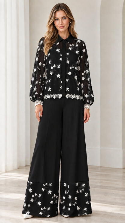Model wearing black floral embroidered lace shirt and wide leg pant set