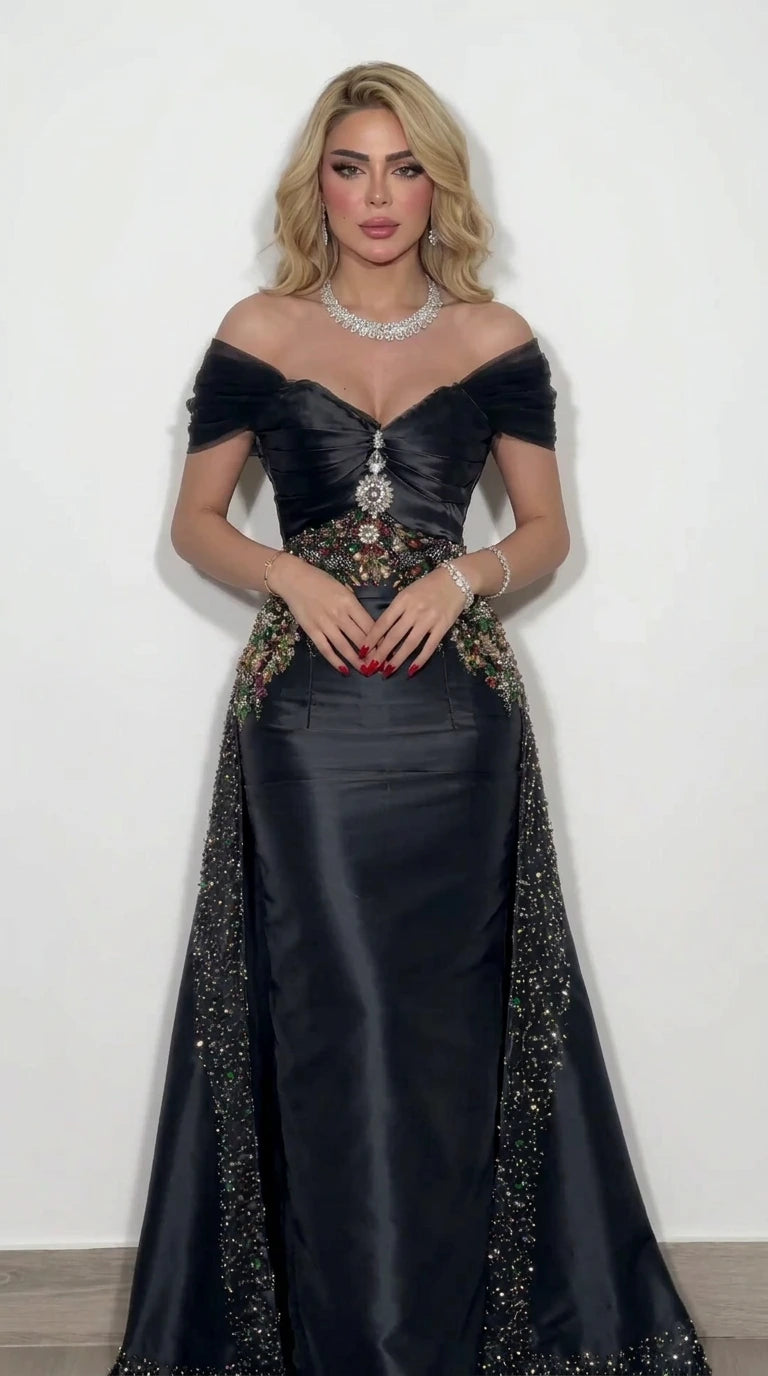 Model wearing black off-the-shoulder beaded satin evening dress