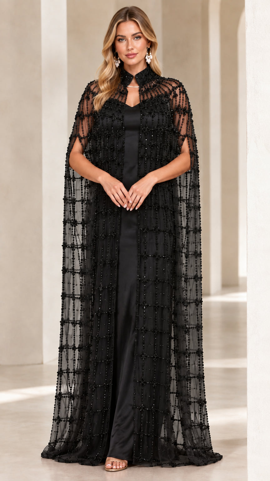 Black floor-length evening gown with matching beaded cape overlay