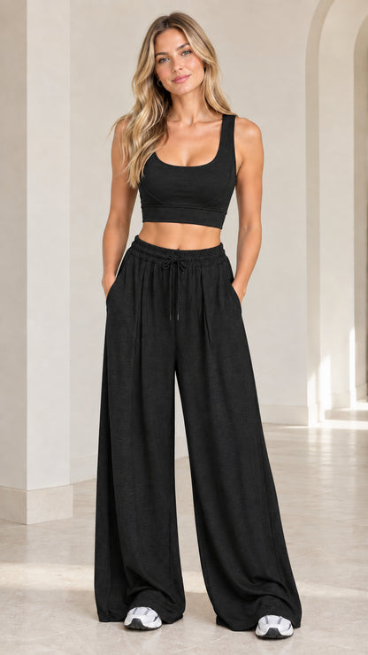 Front view of woman wearing Black 2-piece crop tank and wide-leg lounge set