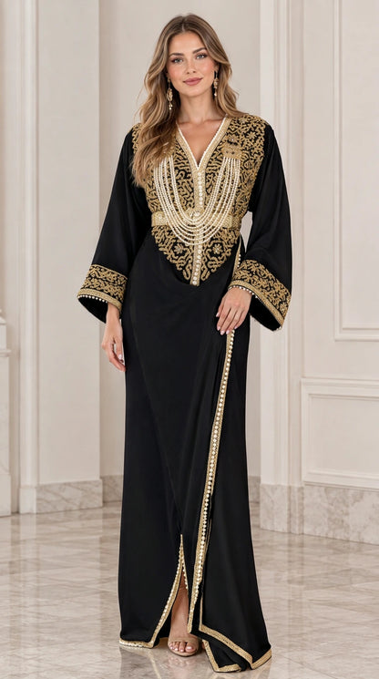 Front view of model wearing black kaftan maxi dress with gold embroidery