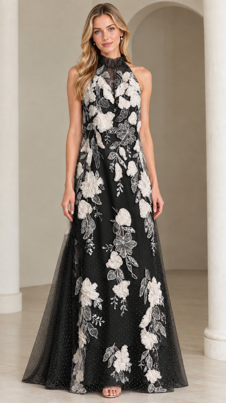 Front view of black halter maxi dress with contrasting white floral appliques
