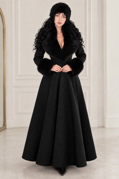 Front view of woman wearing classic black maxi swing coat with black faux fur trim