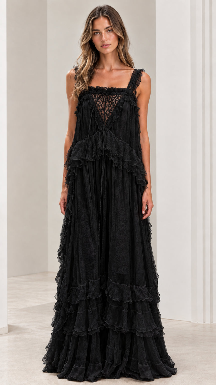 Front view of woman wearing black lace bodice tiered maxi dress