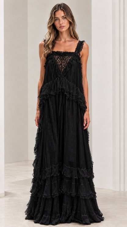 Front view of woman wearing black lace bodice tiered maxi dress
