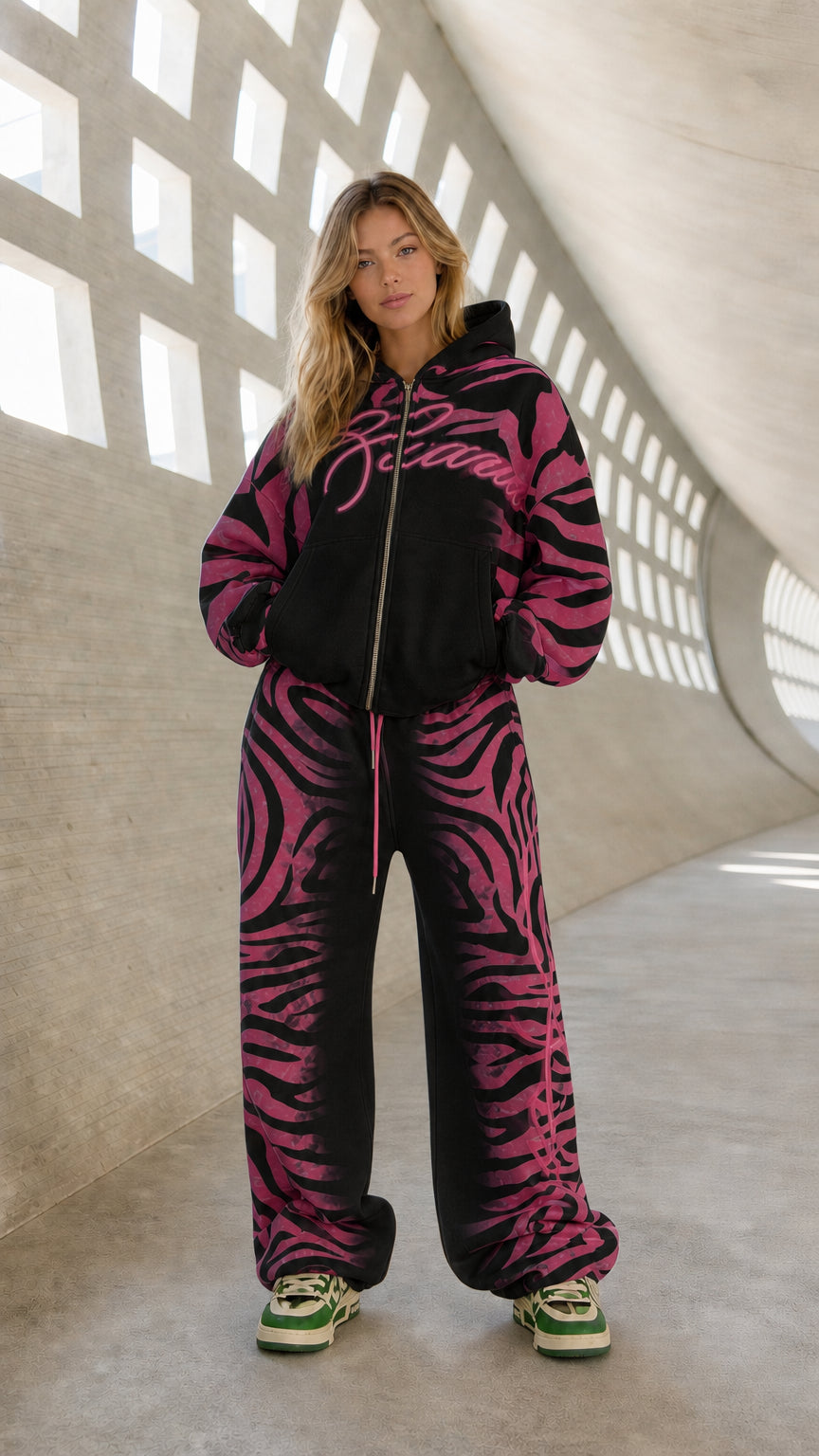 Full front view of model wearing black and magenta pink graphic tracksuit set