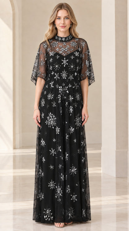 Front view of woman wearing black starburst beaded evening gown with flutter sleeves