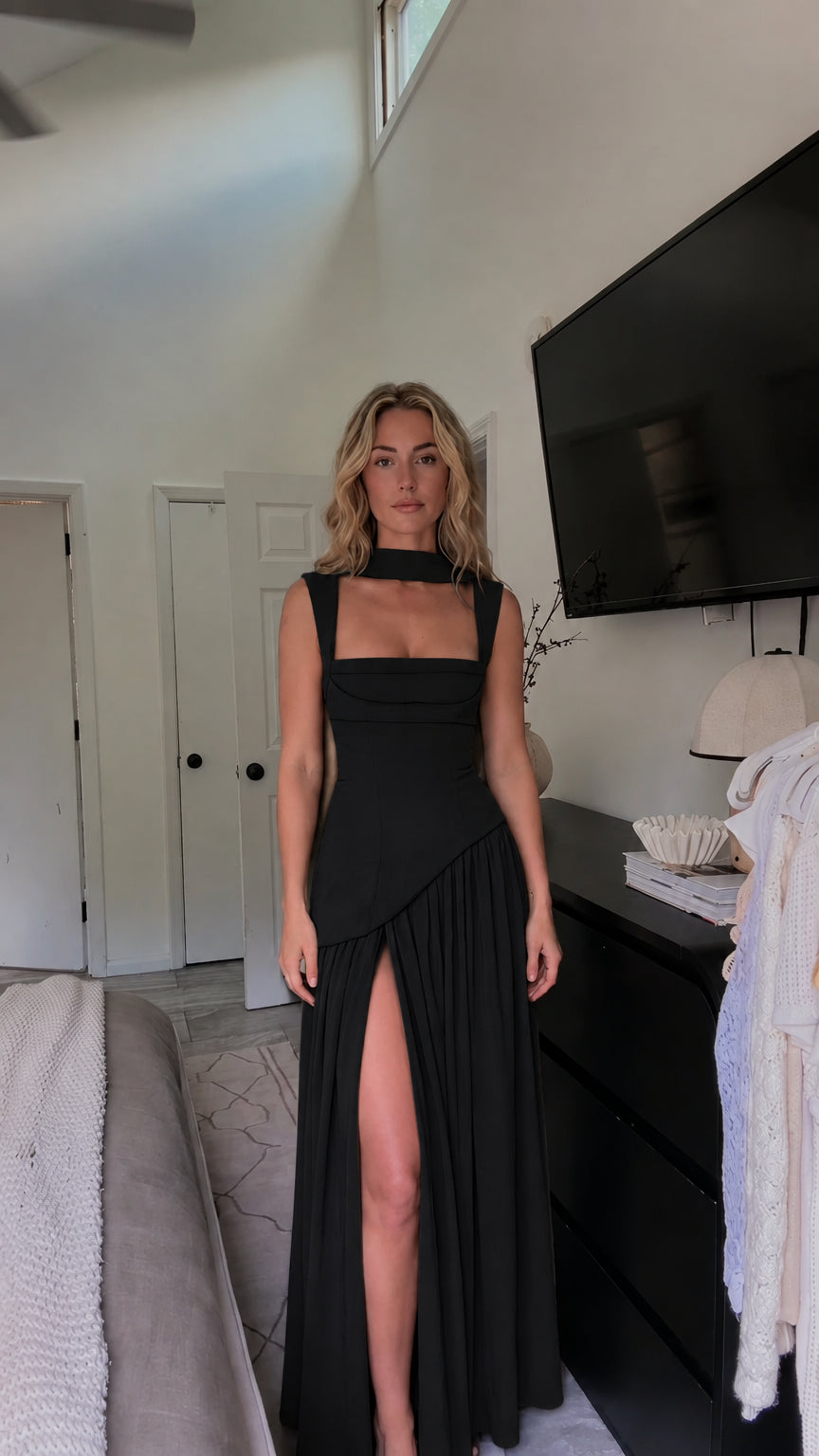 Front view of model wearing black choker neck pleated maxi dress