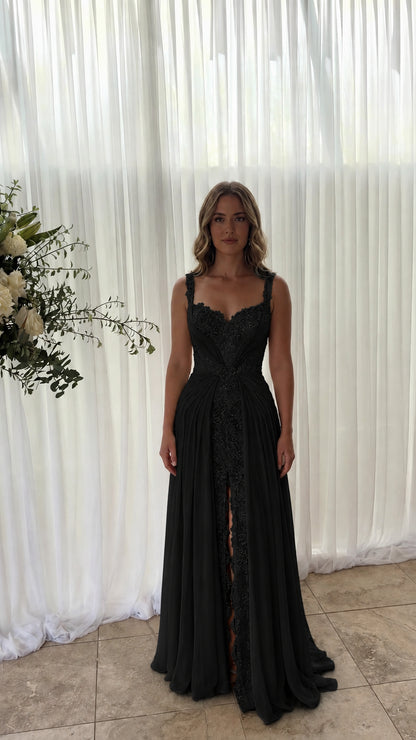 Front view of model wearing black lace inset pleated chiffon maxi dress