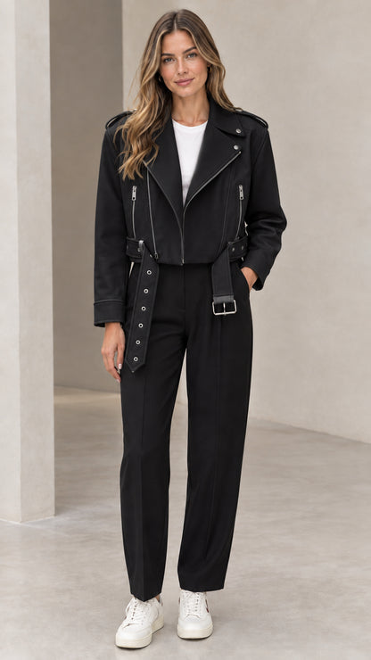 Front view of woman wearing black cropped faux leather moto biker jacket