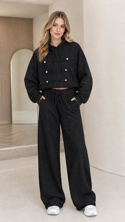 Full-body view of model wearing black cropped hoodie and wide leg lounge set