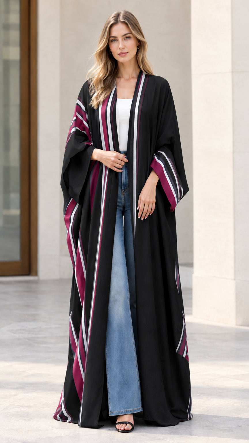 Full-length front view of woman wearing black striped open front maxi kimono duster