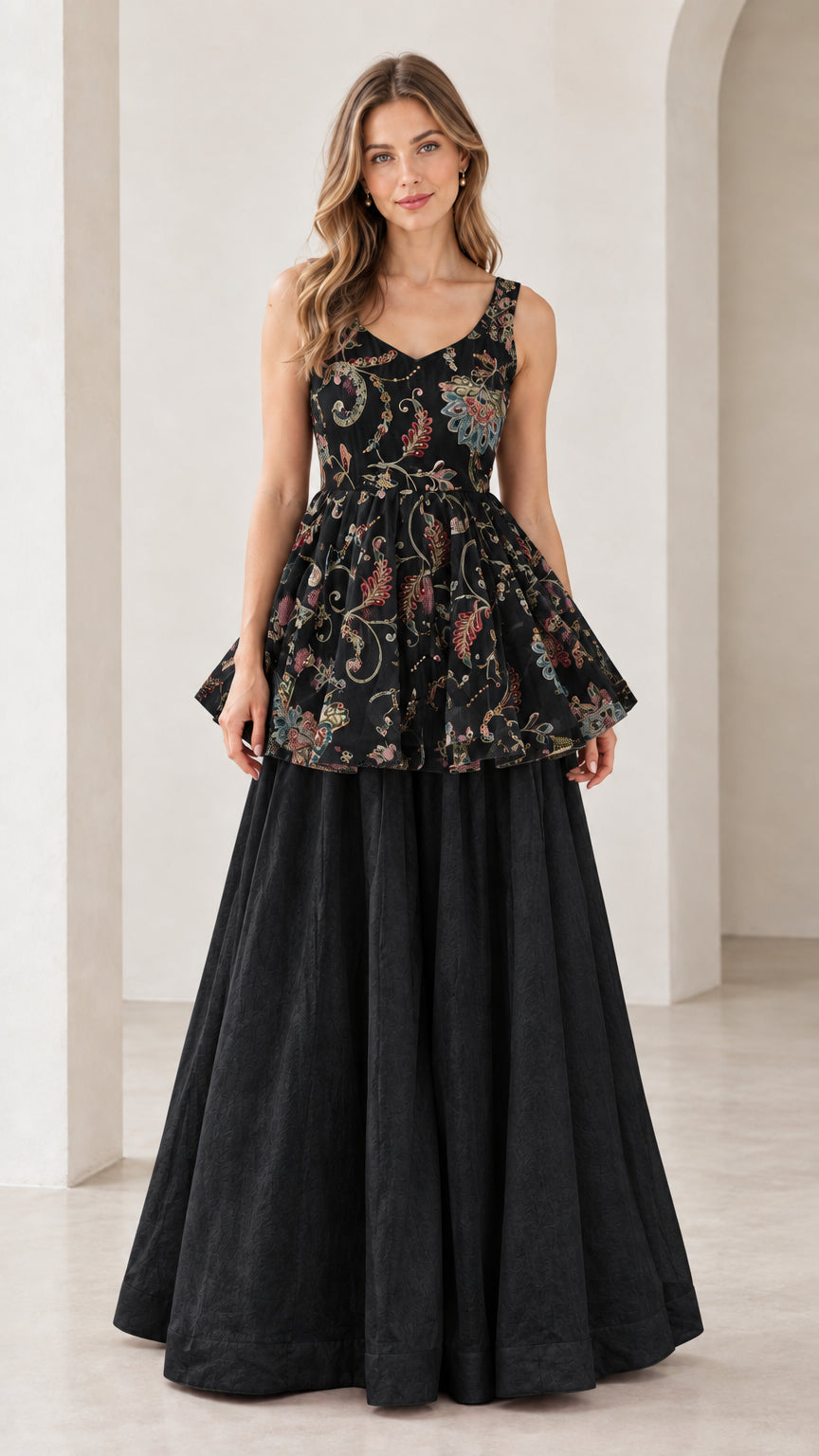 Front view of model wearing black floral embroidered peplum and palazzo set