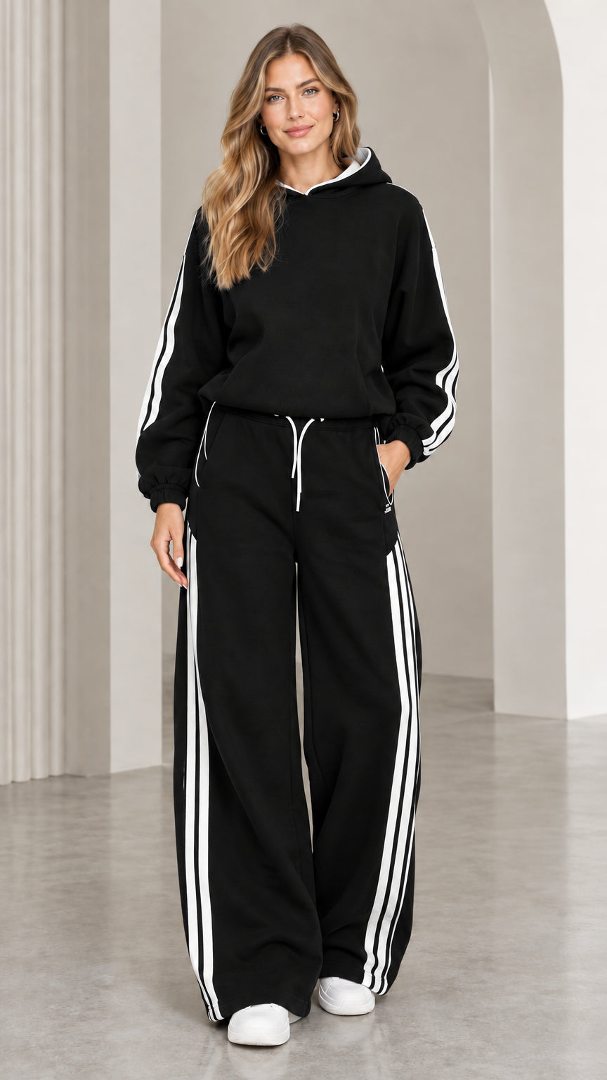 Black two-piece hoodie and wide leg sweatpants tracksuit set with white side stripes