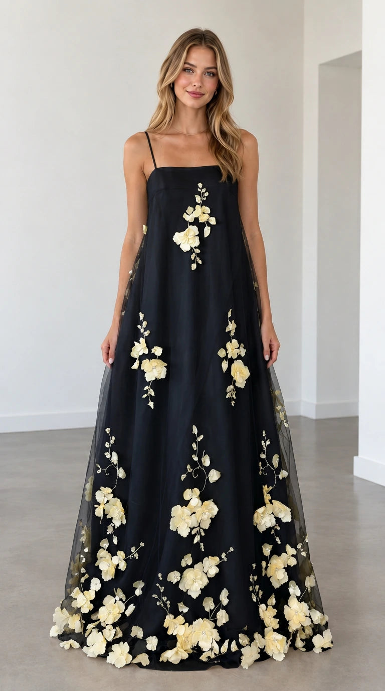 Model wearing black 3D floral applique spaghetti strap maxi dress