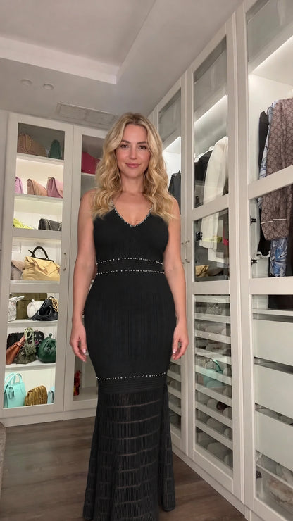 Front view of woman wearing black sleeveless embellished knit mermaid dress