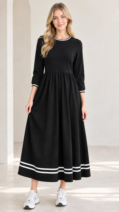 Front view of model wearing black 3/4 sleeve maxi dress with white striped trim