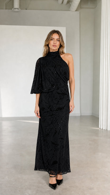 Model wearing black one-shoulder high neck embellished maxi evening gown