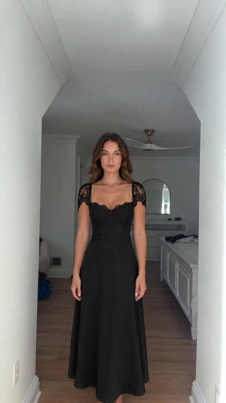 Model wearing black lace cap-sleeve corset bodice maxi dress