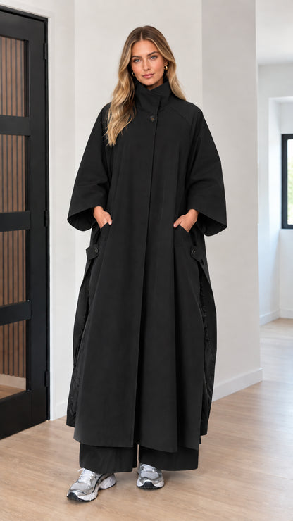 Front full-length view of woman wearing black oversized maxi cape coat