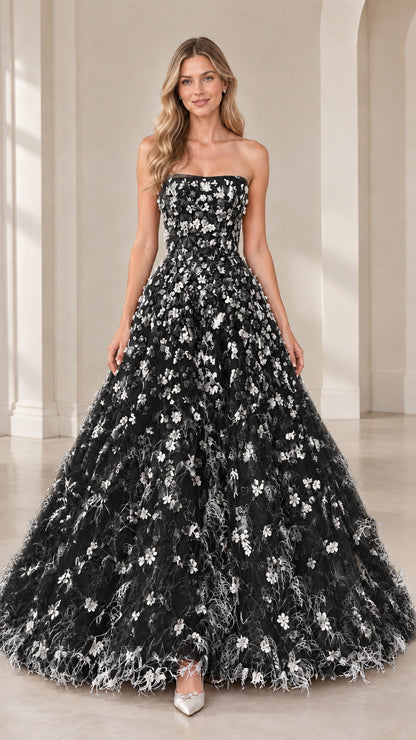 Model wearing strapless black floral applique formal evening gown