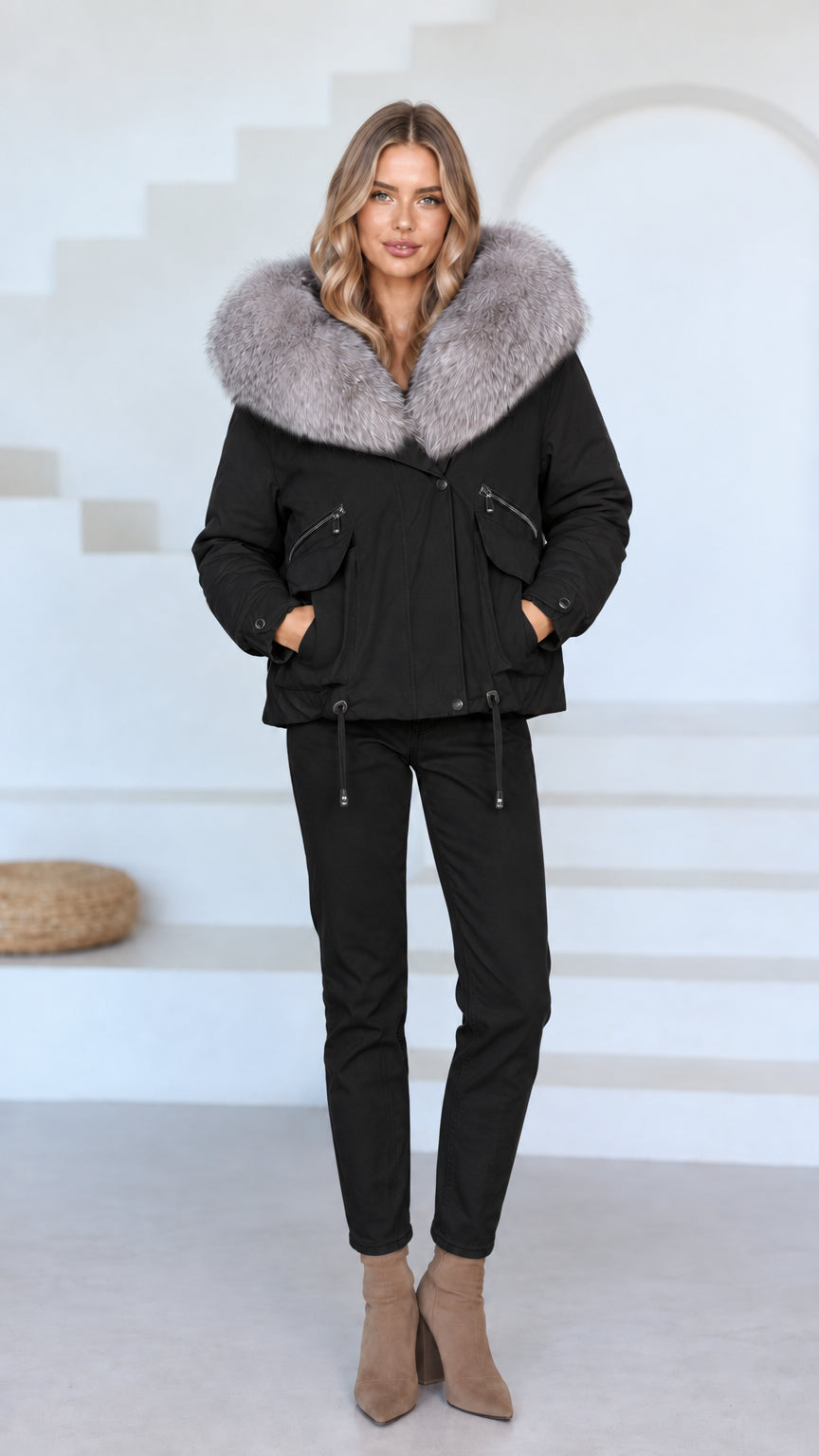 Front view of model wearing black faux fur hooded jacket and matching black pants