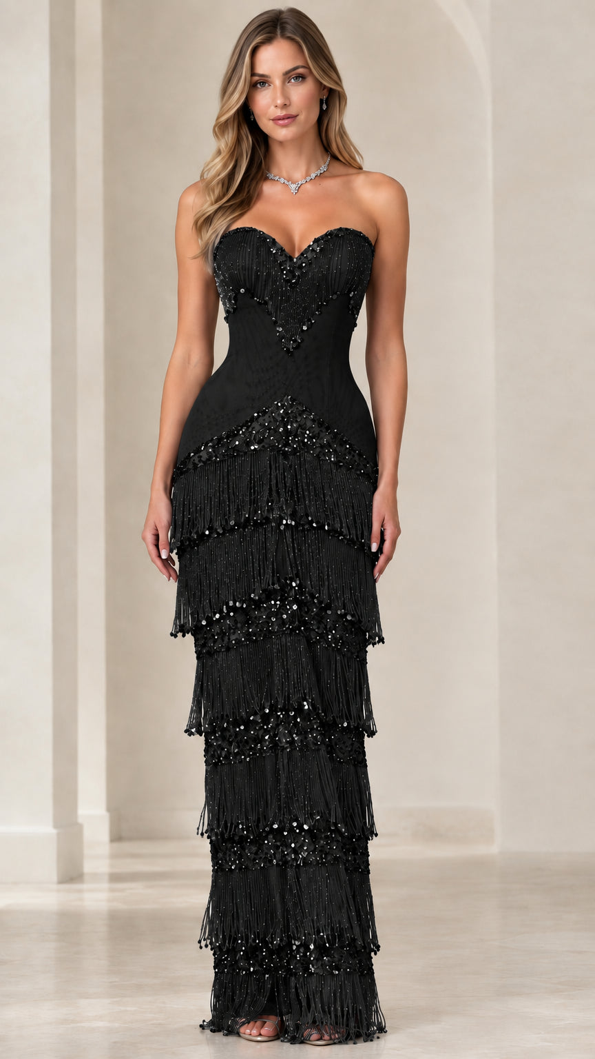 Front view of black strapless sweetheart tiered fringe formal gown