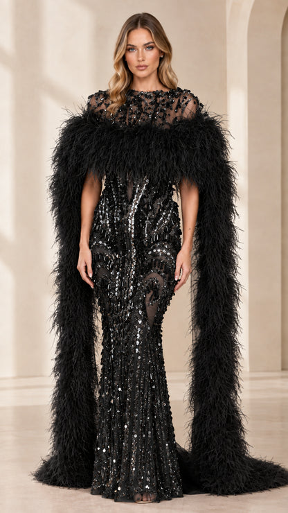 Full-length view of black beaded mermaid gown with black feather cape